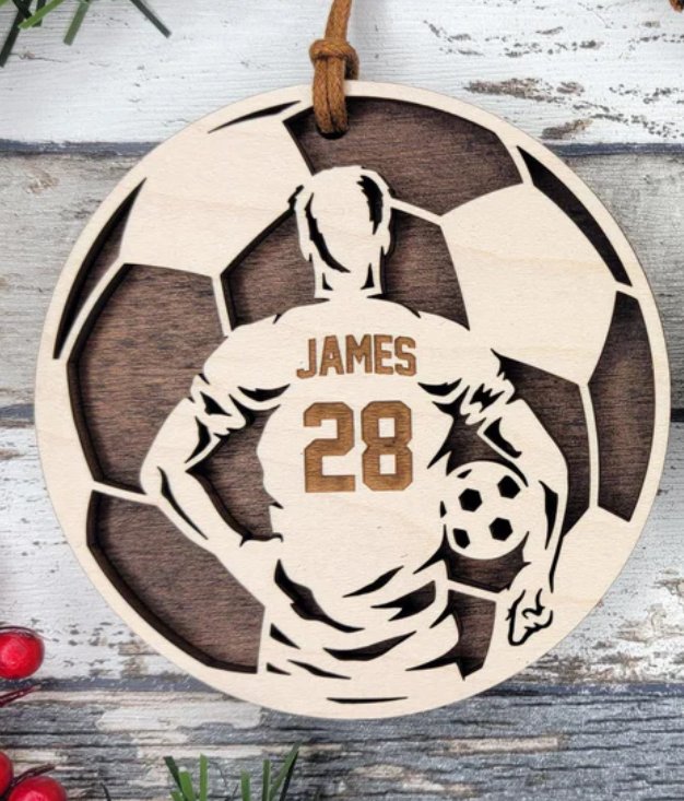 Personalized soccer ornament with player name James and number 28, laser engraved on wood